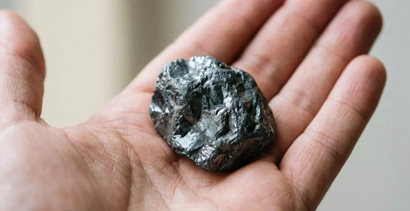 Gros plan sur une main tenant une pierre d'hématite naturelle pour tester l'ancrage énergétique